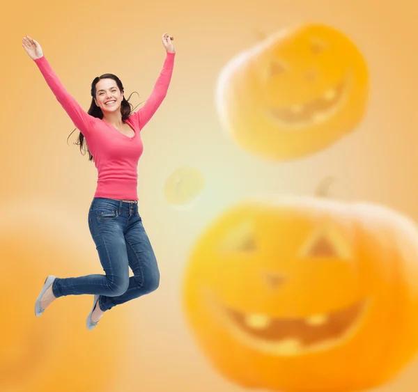 Smiling young woman jumping in air — Stock Photo, Image