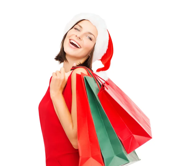 Woman in red dress with shopping bags — Stock Photo, Image