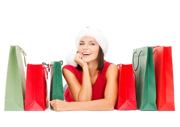 Woman in red shirt with shopping bags — Stock Photo, Image