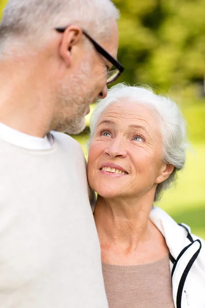 Senior couple hugging in city park — ストック写真