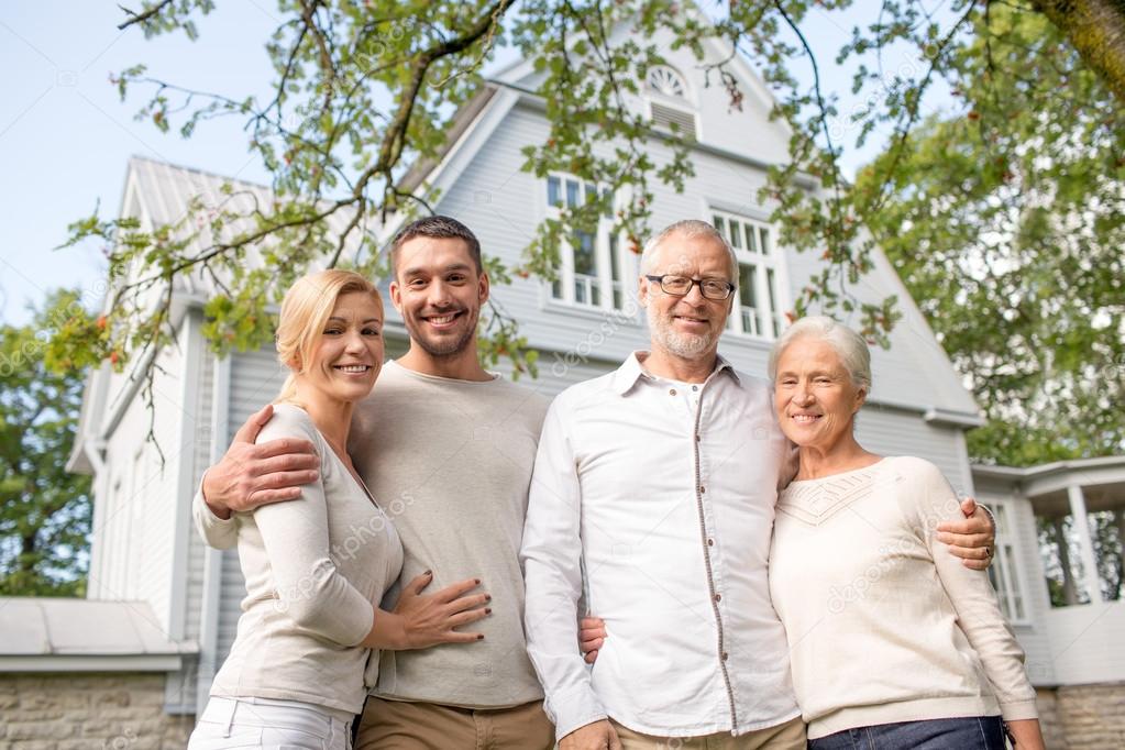 Happy family in front of house outdoors — Stock Photo © Syda