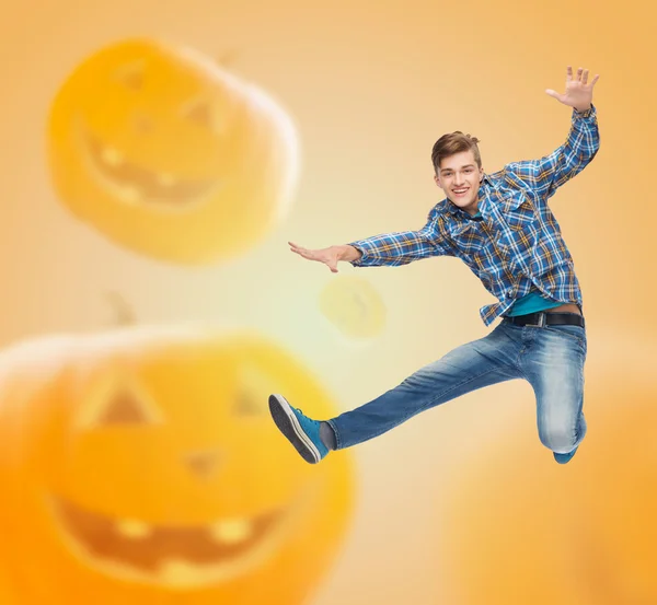 Smiling young man jumping in air — Stock Photo, Image