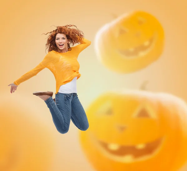 Smiling young woman jumping in air — Stock Photo, Image
