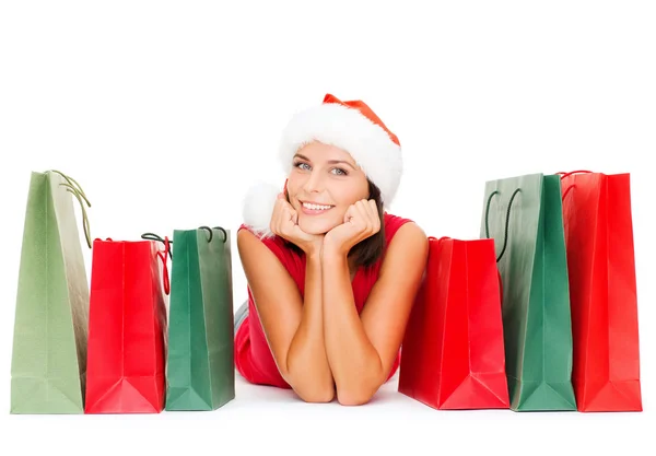 Woman in red shirt with shopping bags — Stock Photo, Image
