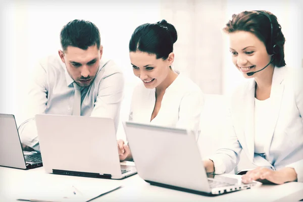 Group of people working with laptops in office — Stock Photo, Image