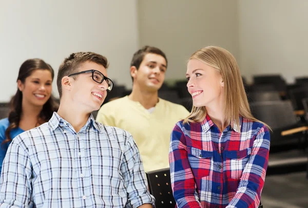 Group of smiling students in lecture hall — Stock Photo, Image