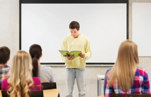 Group of smiling students in classroom — Stock Photo, Image