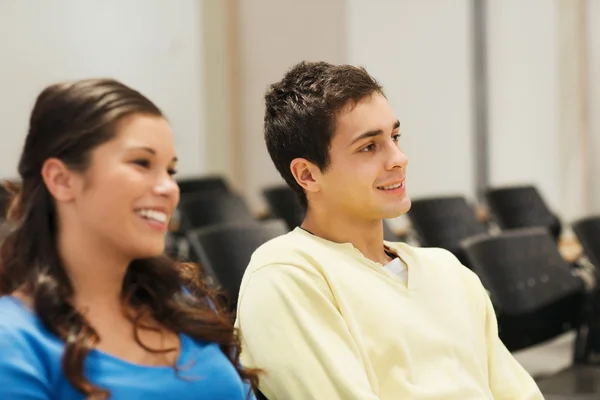 Group of smiling students in lecture hall — Stock Photo, Image