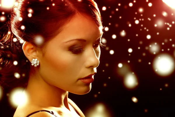 Woman in evening dress wearing diamond earrings — Stock Photo, Image