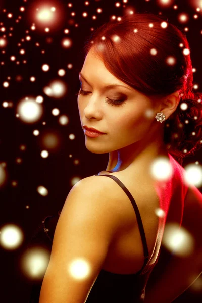 Woman in evening dress wearing diamond earrings — Stock Photo, Image