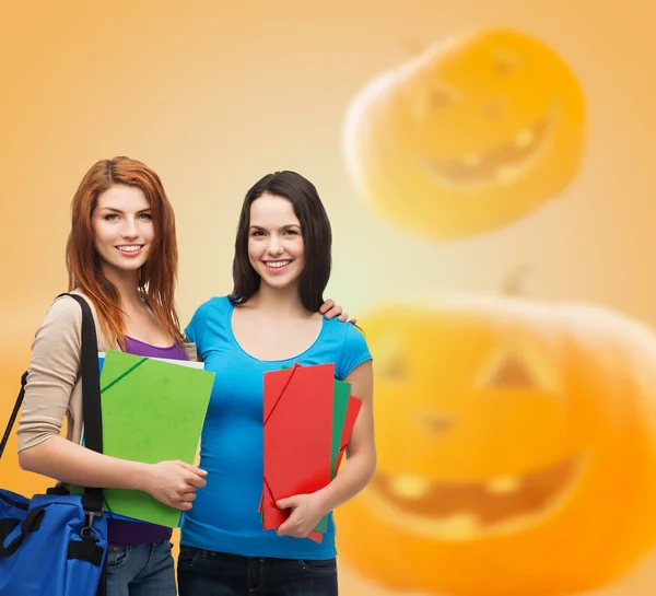 Smiling student girl with books and bag — Stock Photo, Image