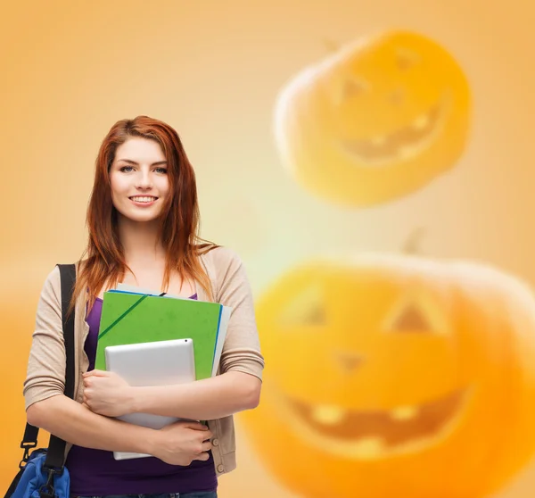 Smiling student girl with books and bag — Stock Photo, Image