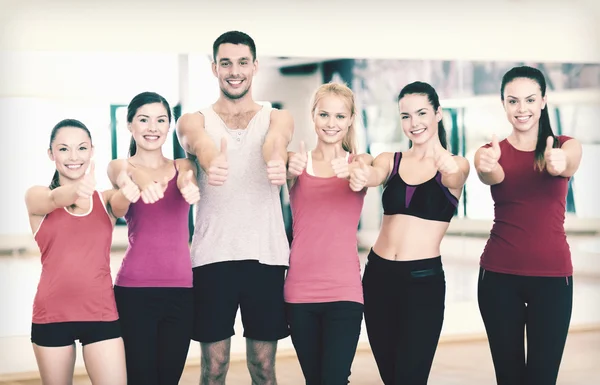 Groupe de personnes dans la salle de gym montrant pouces vers le haut — Photo