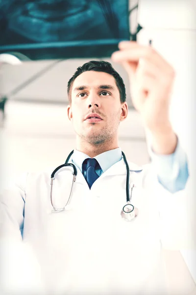 Male doctor or dentist looking at x-ray — Stock Photo, Image