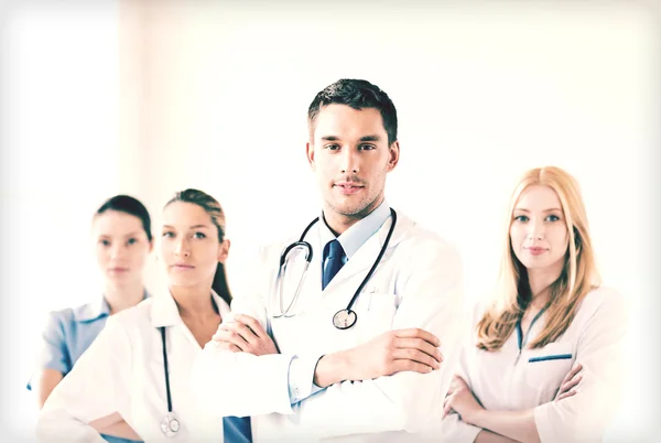 Male doctor in front of medical group — Stock Photo, Image