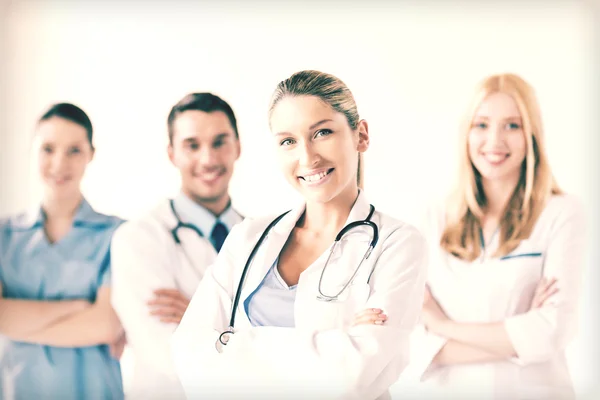 Female doctor in front of medical group — Stock Photo, Image