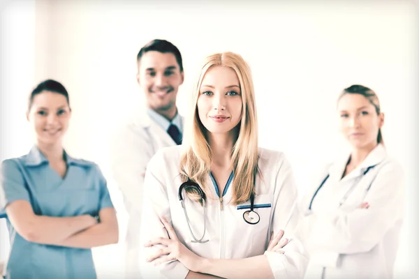 Female doctor in front of medical group — Stock Photo, Image