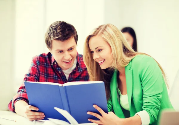 Girl and guy reading book at school — Stock Photo, Image