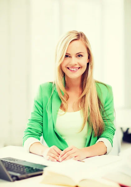 Chica estudiante sonriente con portátil en la escuela — Foto de Stock