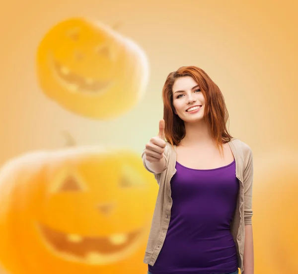 Smiling teenage girl showing thumbs up — Stock Photo, Image