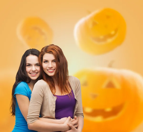 Smiling teenage girls hugging — Stock Photo, Image