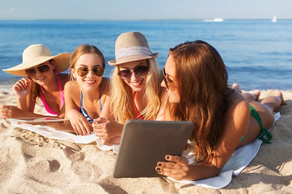A fiatal nők a tabletta a strand mosolygós csoport — Stock Fotó