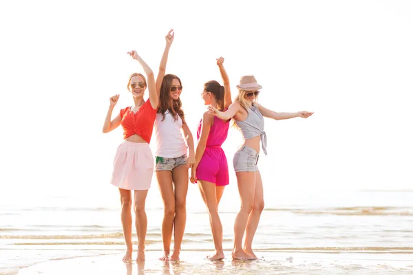 Group of smiling women dancing on beach Royalty Free Stock Images