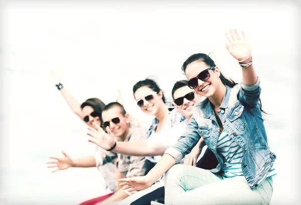 Group of teenagers waving hands — Stock Photo, Image