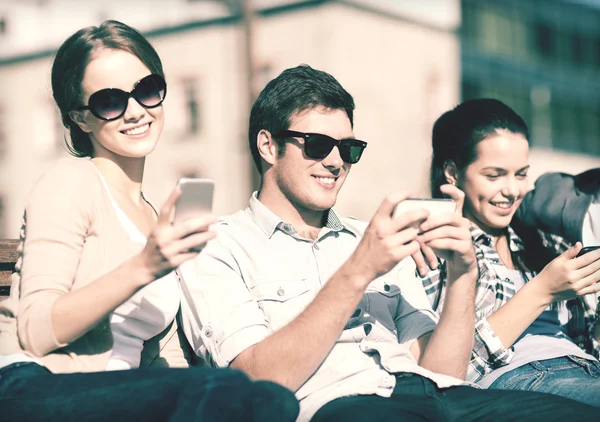 Studenti při pohledu na smartphone a tablet pc — Stock fotografie