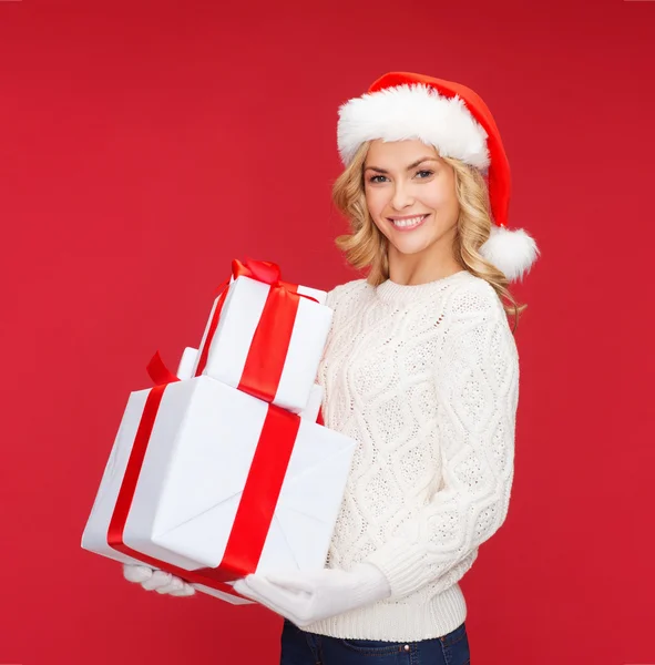 Woman in santa helper hat with many gift boxes — Stock Photo, Image