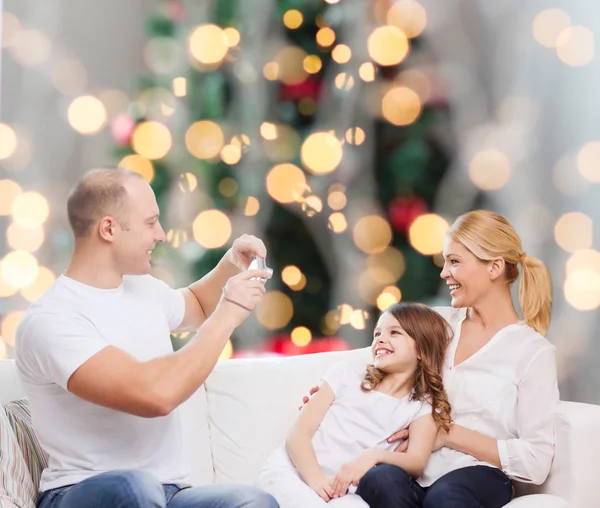 Happy family with camera at home — Stock Photo, Image