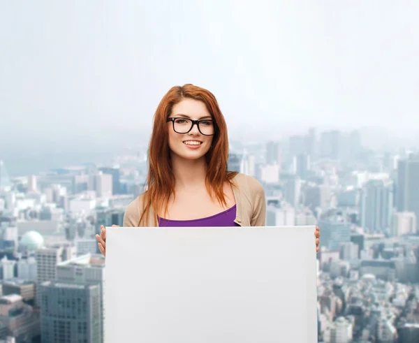 Smiling teenage girl in glasses with white board — Stock Photo, Image