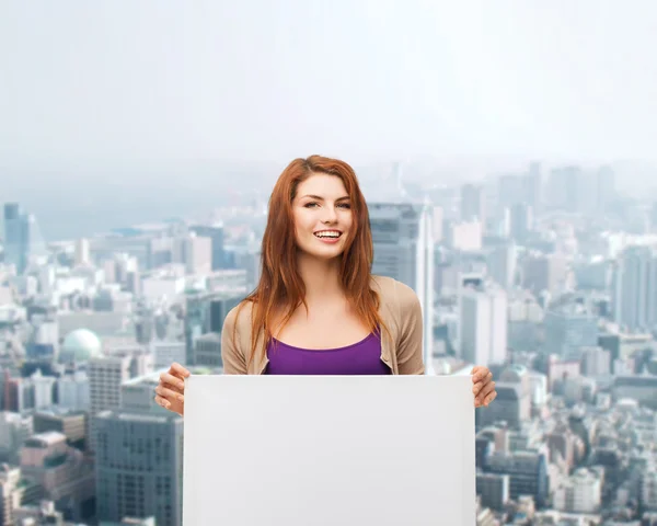 Smiling teenage girl with white board — Stock Photo, Image