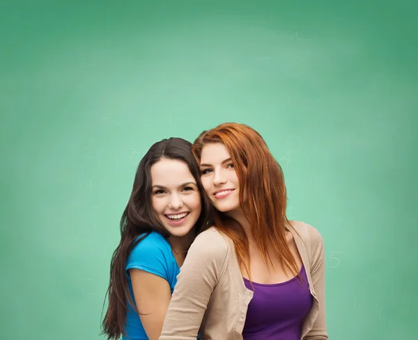 Smiling teenage girls hugging — Stock Photo, Image