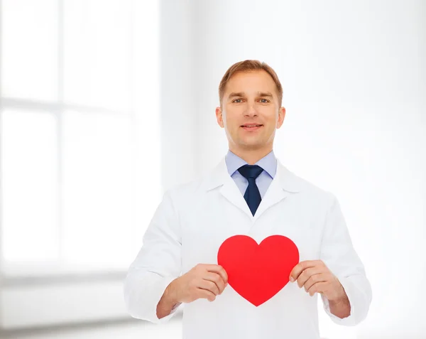 Smiling male doctor with red heart — Stock Photo, Image