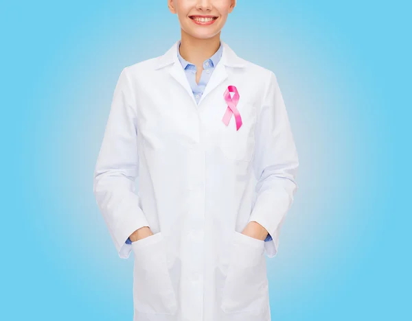 Close up of doctor with cancer awareness ribbon — Stock Photo, Image