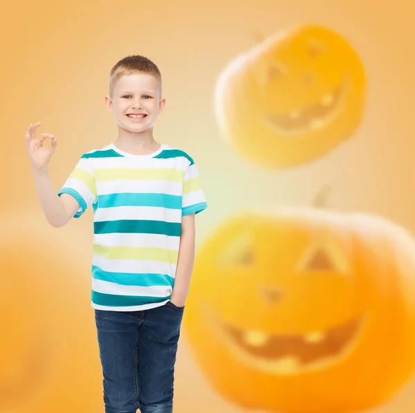 Smiling boy over pumpkins background — Stock Photo, Image