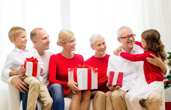 Família sorridente com presentes em casa — Fotografia de Stock