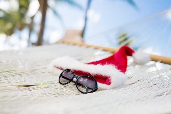 Hammock with santa helper hat and shades — Stock Photo, Image