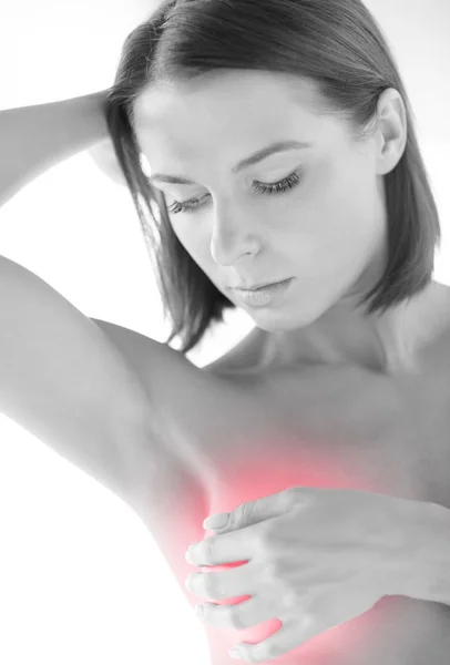 Woman checking breast for signs of cancer — Stock Photo, Image