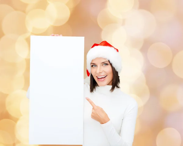 Sorridente giovane donna in cappello di Babbo Natale con tavola bianca — Foto Stock