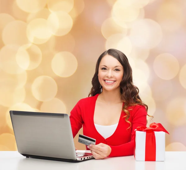 Mulher sorridente com cartão de crédito e laptop — Fotografia de Stock