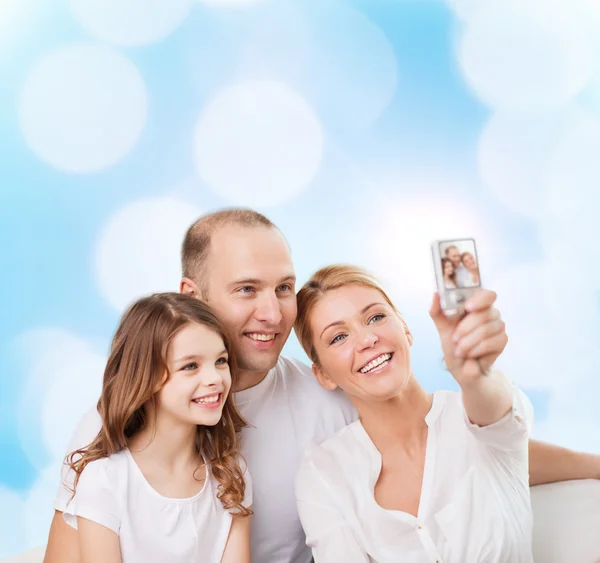 Happy family with camera at home — Stock Photo, Image