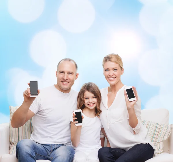 Happy family with smartphones — Stock Photo, Image