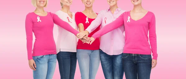 Close up of women with cancer awareness ribbons — Stock Photo, Image