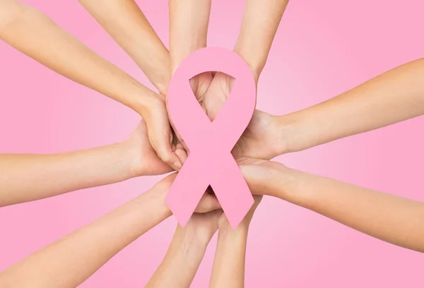 Close up of hands with cancer awareness symbol — Stock Photo, Image