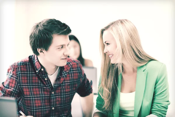 Smiling students looking at each other at school — Stock Photo, Image