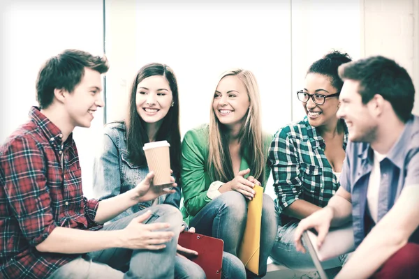 Students communicating and laughing at school — Stock Photo, Image