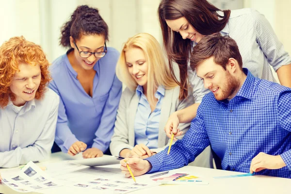 Smiling team with color samples at office — Stock Photo, Image