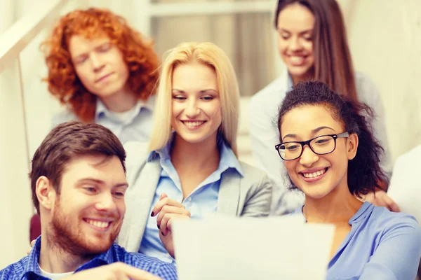 Team with papers and take away coffee on staircase — Stock Photo, Image